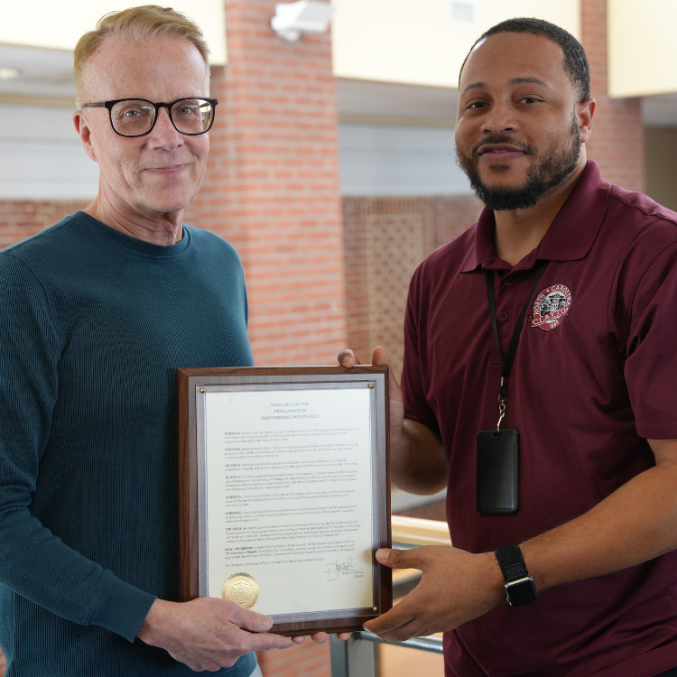 Procurement Manager Shaun Mizell and Procurement Technician Derryel Anderson Hold Proclamation